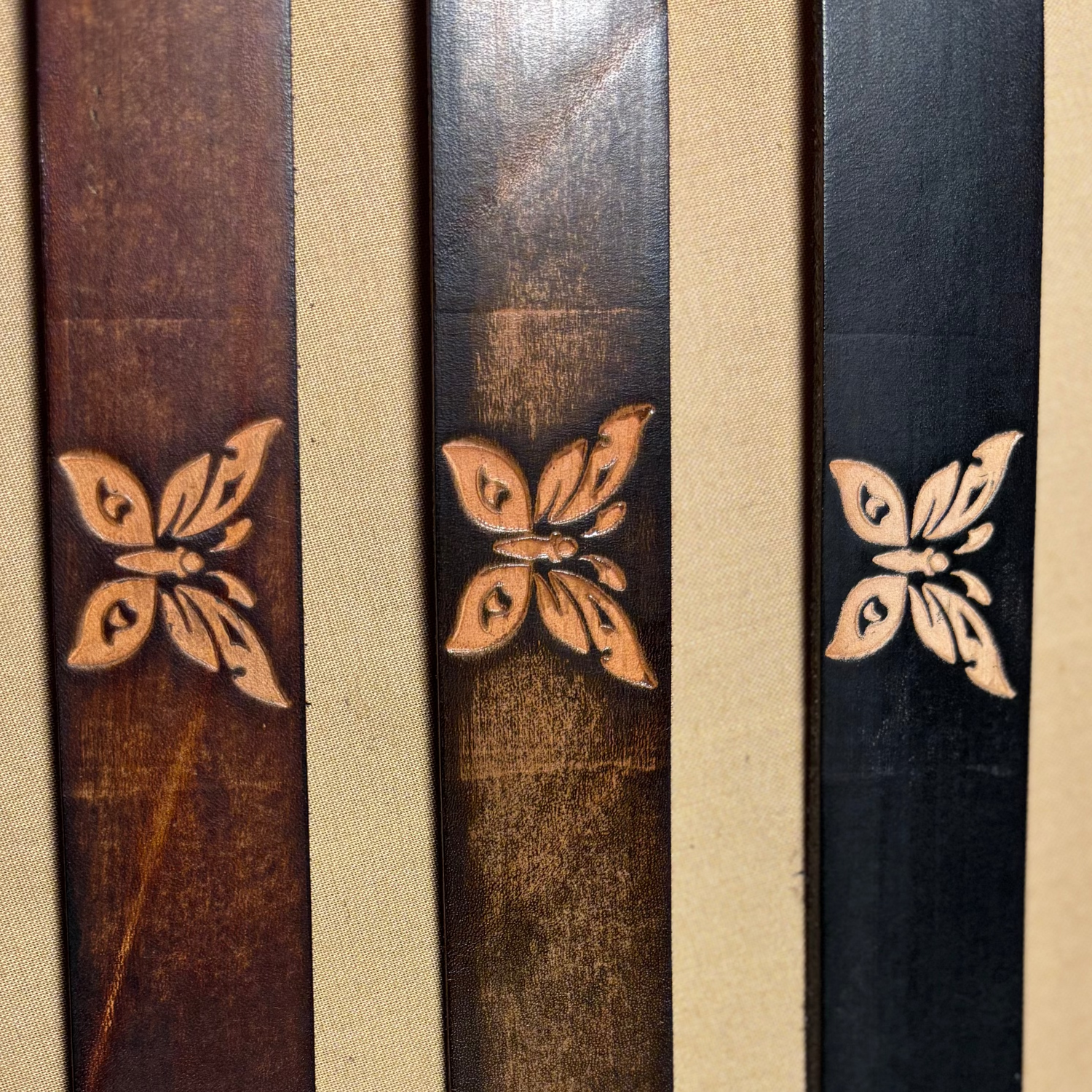 assorted leather buttfly belts on tan