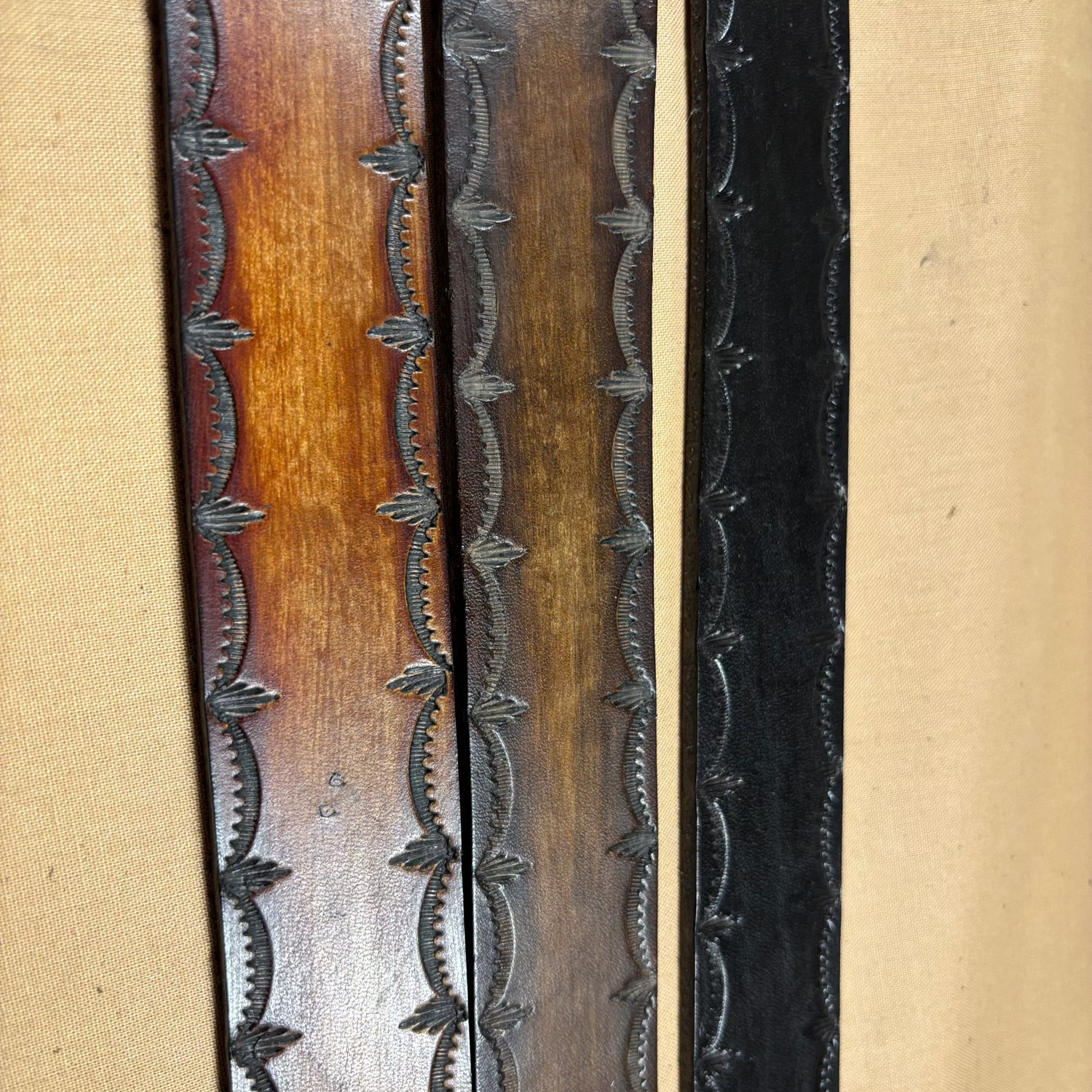 Close-up of a decorative metal strip with embossed patterns on a beige background