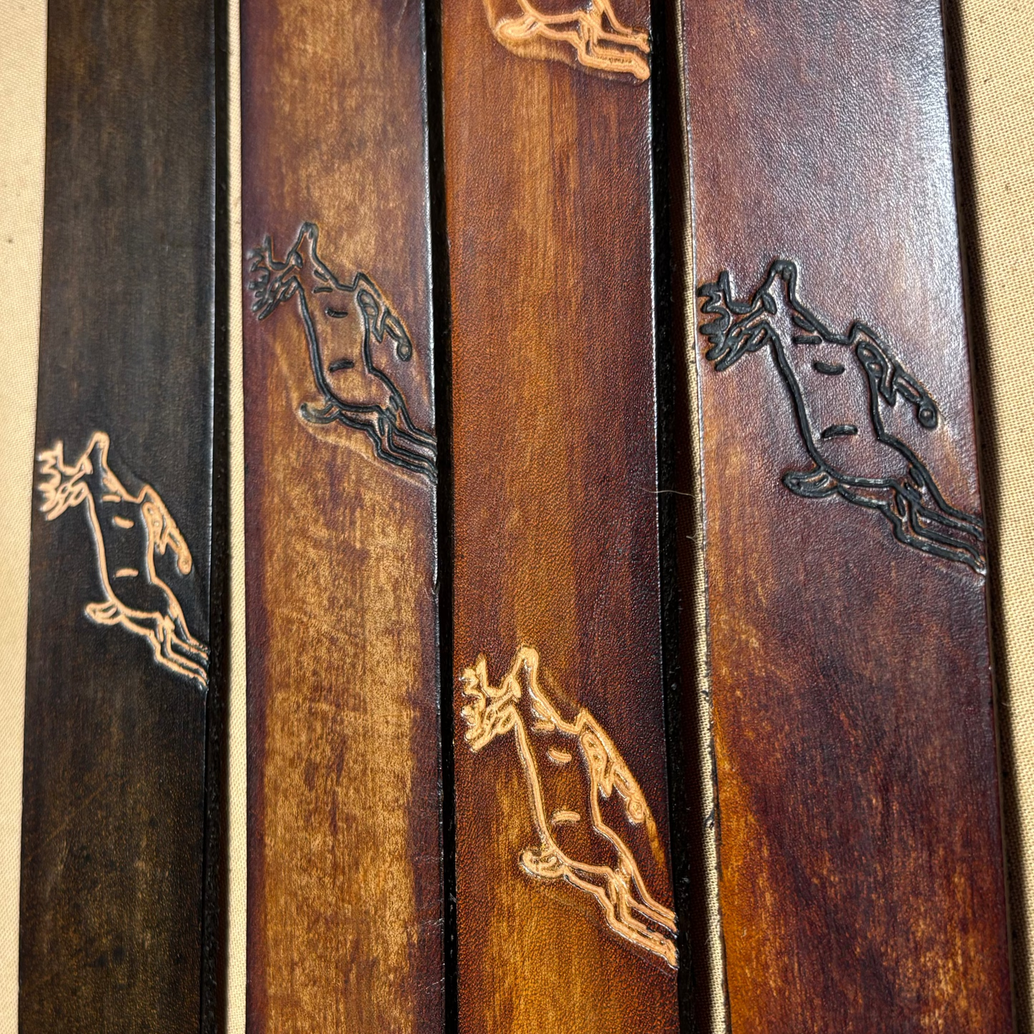 Wooden sticks with engraved animal figures on a beige background